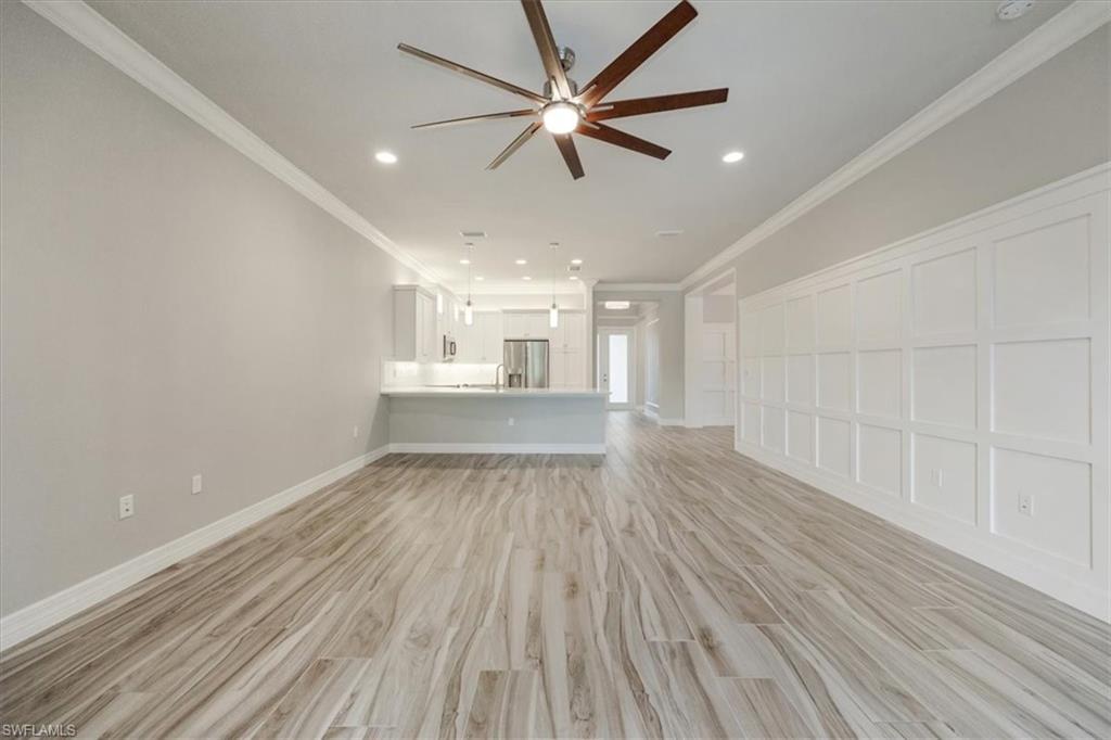 13418 Silktail Drive Naples, FL 34109 - Photo 15 of 36 wooden floor in an empty room with a window