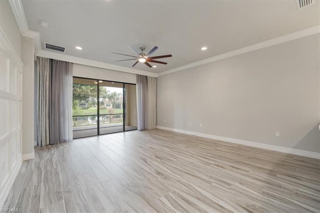13418 Silktail Drive Naples, FL 34109 - Photo 20 of 36 a view of an empty room with wooden floor and a window