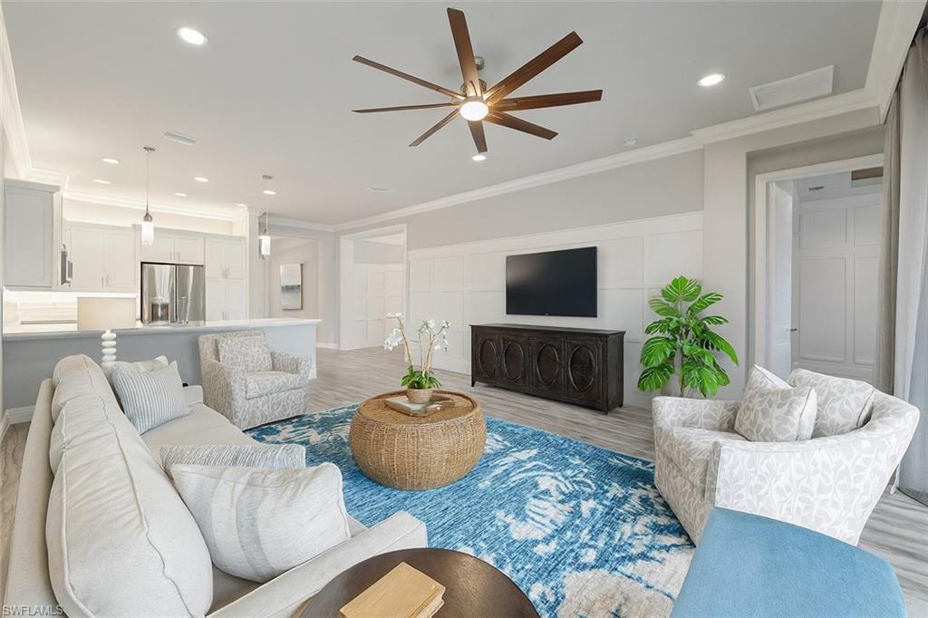 13418 Silktail Drive Naples, FL 34109 - Photo 2 of 36 a living room with furniture and a potted plant