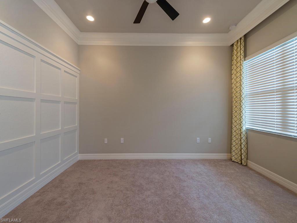 13418 Silktail Drive Naples, FL 34109 - Photo 29 of 36 an empty room with a ceiling fan and window