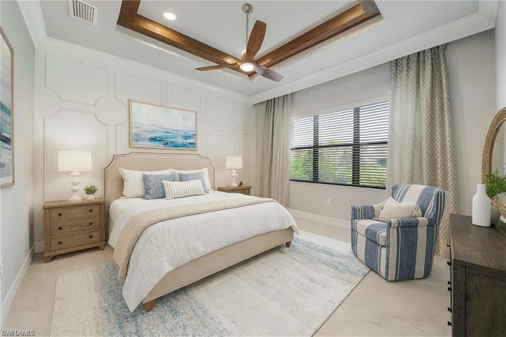 13418 Silktail Drive Naples, FL 34109 - Photo 4 of 36 a spacious bedroom with a bed and a large window