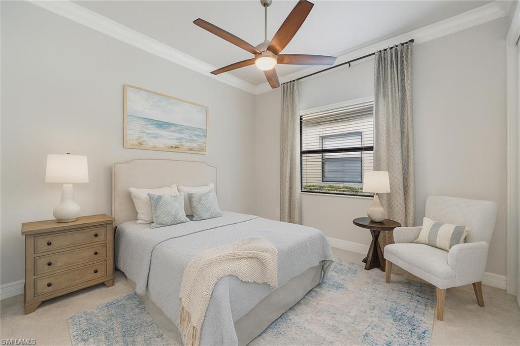 13418 Silktail Drive Naples, FL 34109 - Photo 5 of 36 a bedroom with a bed and a couch