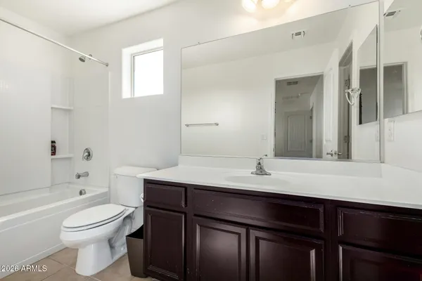 a bathroom with a granite countertop sink toilet a mirror and shower