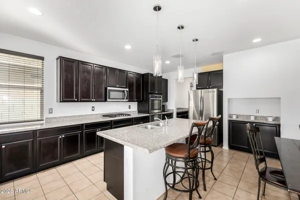 a kitchen with stainless steel appliances a sink stove and refrigerator