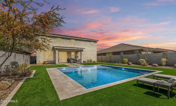 a view of an house with backyard space and balcony