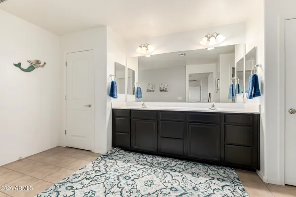 a bathroom with a sink vanity and a mirror