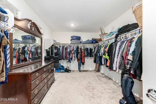 a view of a walk in closet with clothes