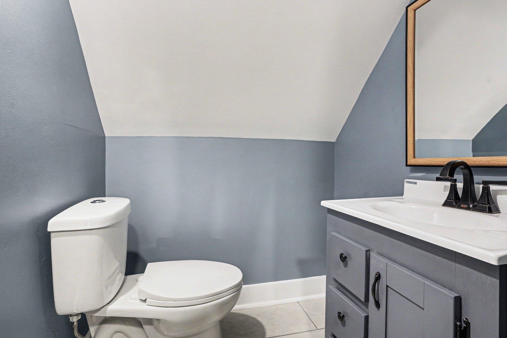 1803 Tennessee Street Michigan City, IN 46360 - Photo 11 of 14 a bathroom with a toilet a sink and a window