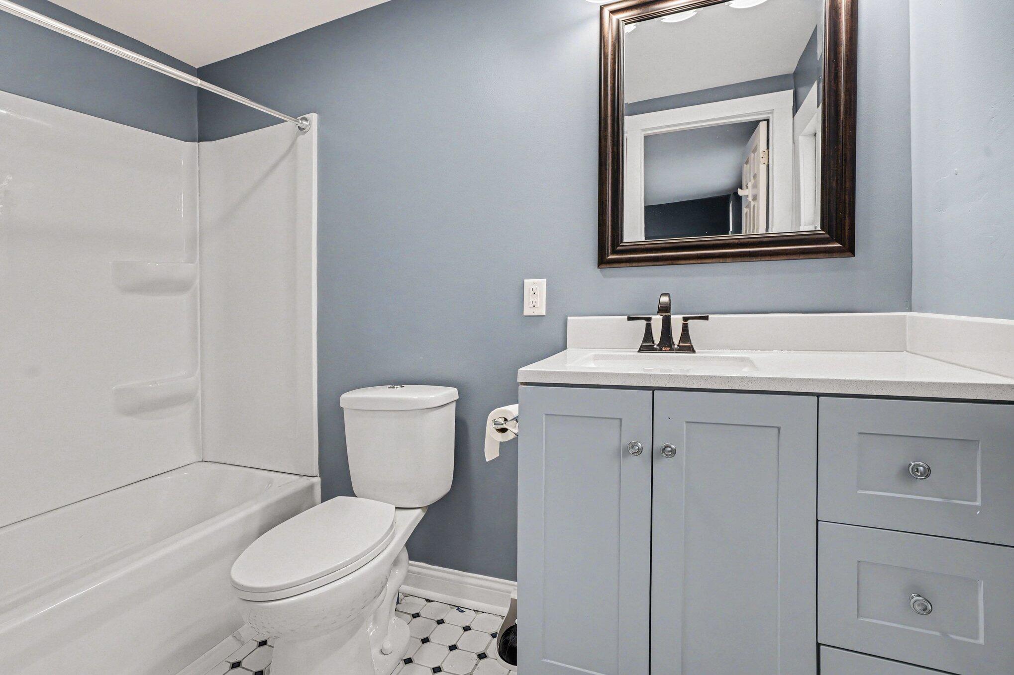 1803 Tennessee Street Michigan City, IN 46360 - Photo 8 of 14 a bathroom with a toilet sink and mirror