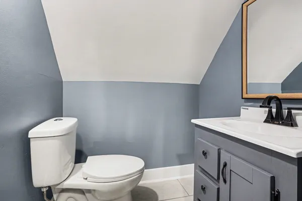 a bathroom with a toilet a sink and a window