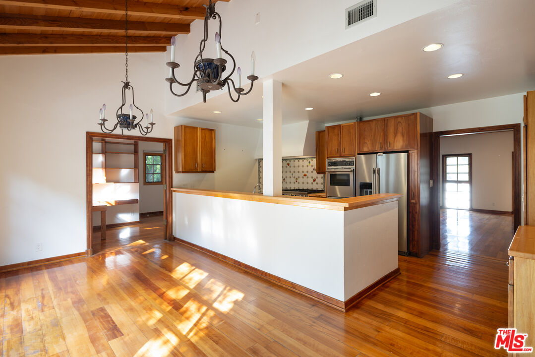 200 Mabery Road Santa Monica, CA 90402 - Photo 5 of 18 a large kitchen with stainless steel appliances kitchen island granite countertop a large counter top and wooden floors