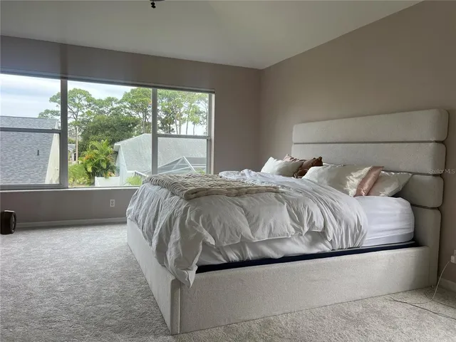 a bedroom with a bed and window