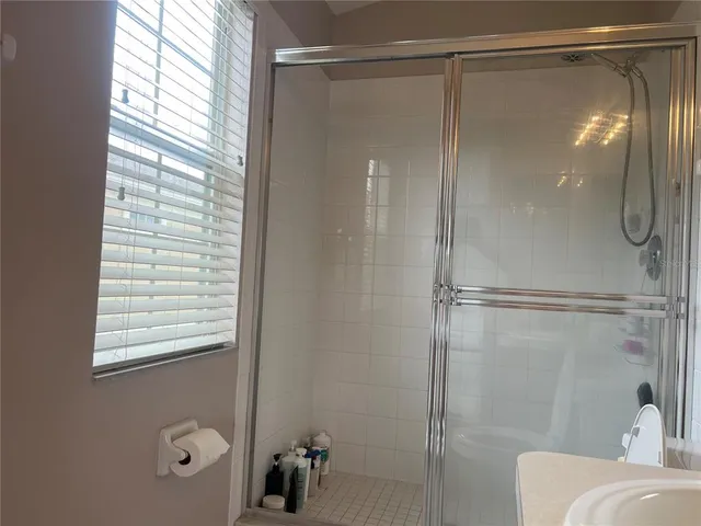 a bathroom with a glass shower door