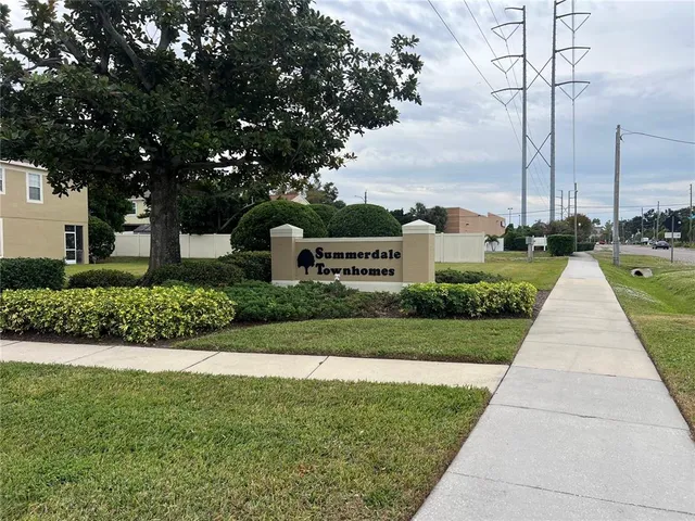 a view of a park with large trees