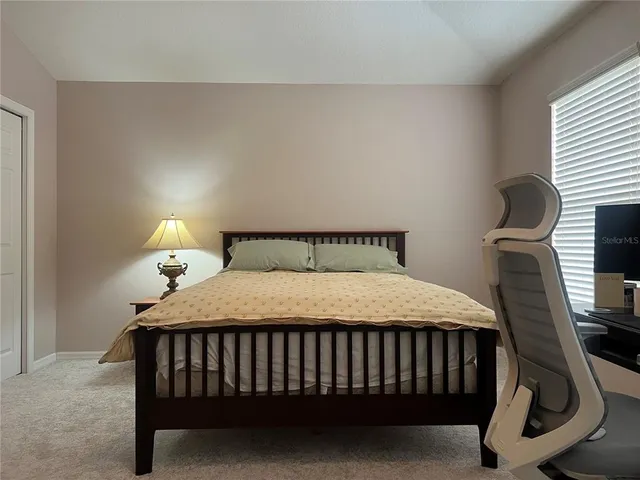 a bedroom with a bed and window