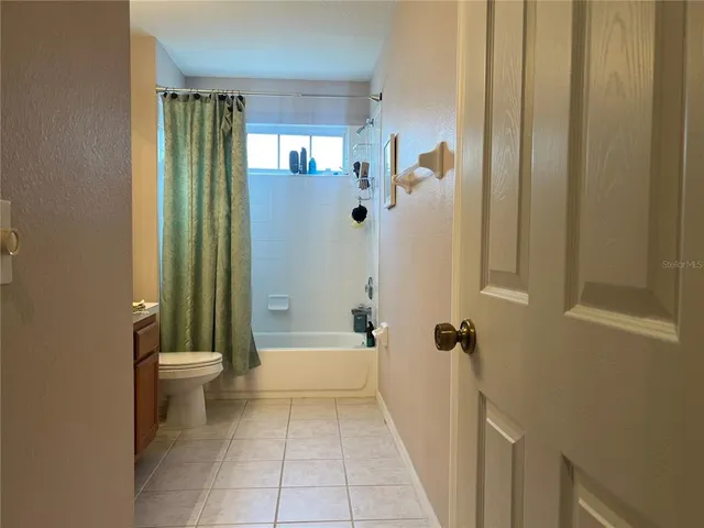 a bathroom with a shower a toilet and a shower