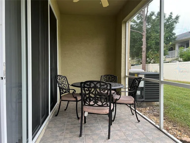 a balcony with table and chairs