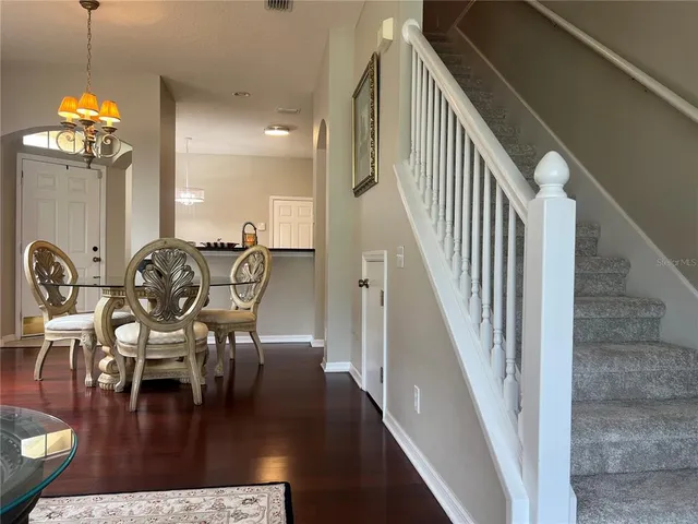 a view of a dining room with furniture and wooden floor