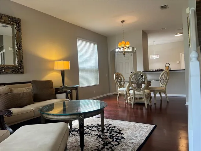 a view of a dining room with furniture and wooden floor