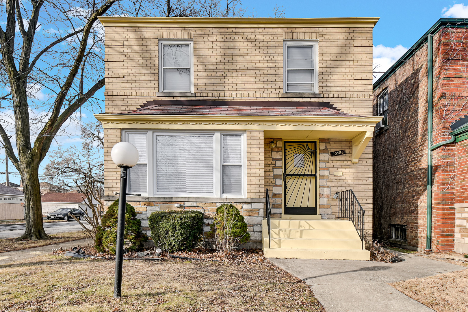 10558 South Prairie Avenue Chicago, IL 60628 - Photo 1 of 16 a front view of a house with garden