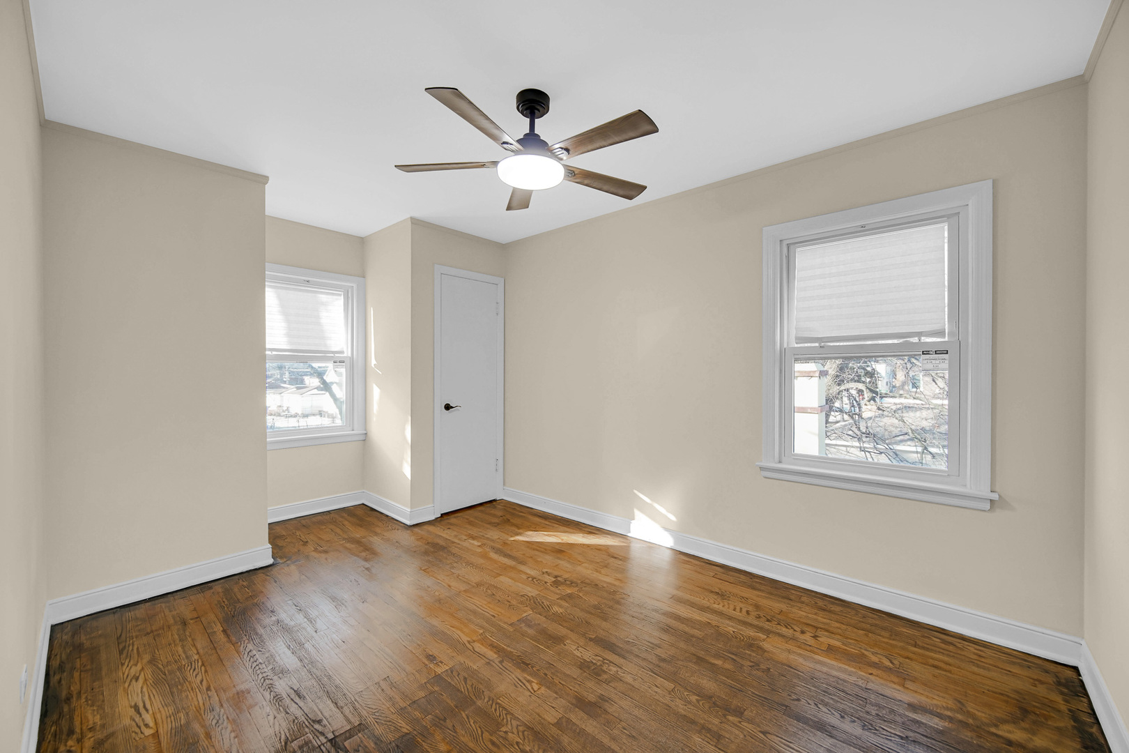 10558 South Prairie Avenue Chicago, IL 60628 - Photo 11 of 16 a view of an empty room with wooden floor and a window