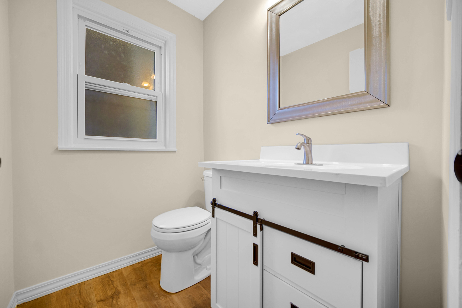 10558 South Prairie Avenue Chicago, IL 60628 - Photo 12 of 16 a bathroom with a sink and a toilet