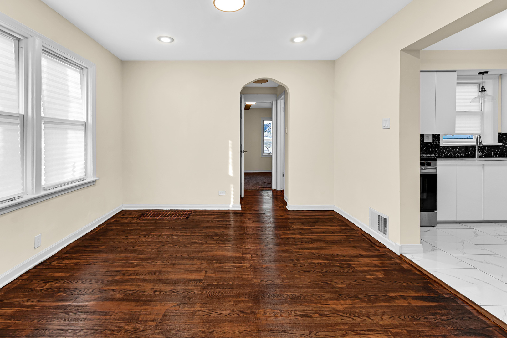 10558 South Prairie Avenue Chicago, IL 60628 - Photo 4 of 16 wooden floor in an empty room with a window
