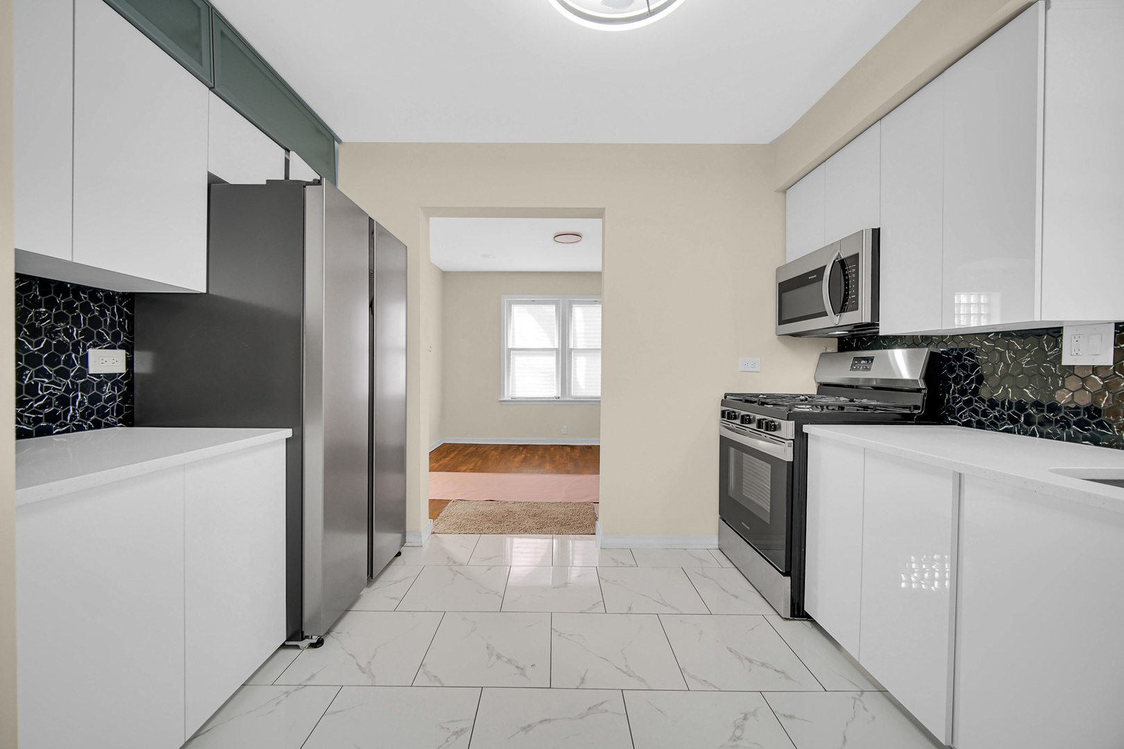 10558 South Prairie Avenue Chicago, IL 60628 - Photo 5 of 16 a kitchen with stainless steel appliances granite countertop a refrigerator and a stove
