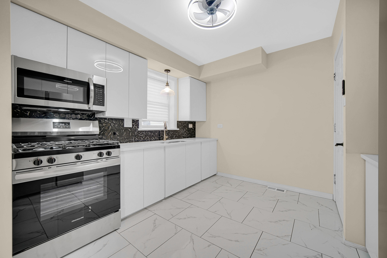 10558 South Prairie Avenue Chicago, IL 60628 - Photo 6 of 16 a kitchen with stainless steel appliances granite countertop a stove top oven a sink and dishwasher