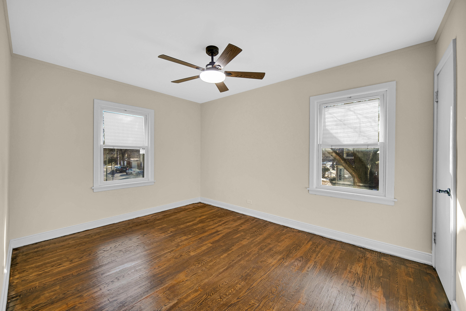 10558 South Prairie Avenue Chicago, IL 60628 - Photo 9 of 16 a view of an empty room with wooden floor and a window