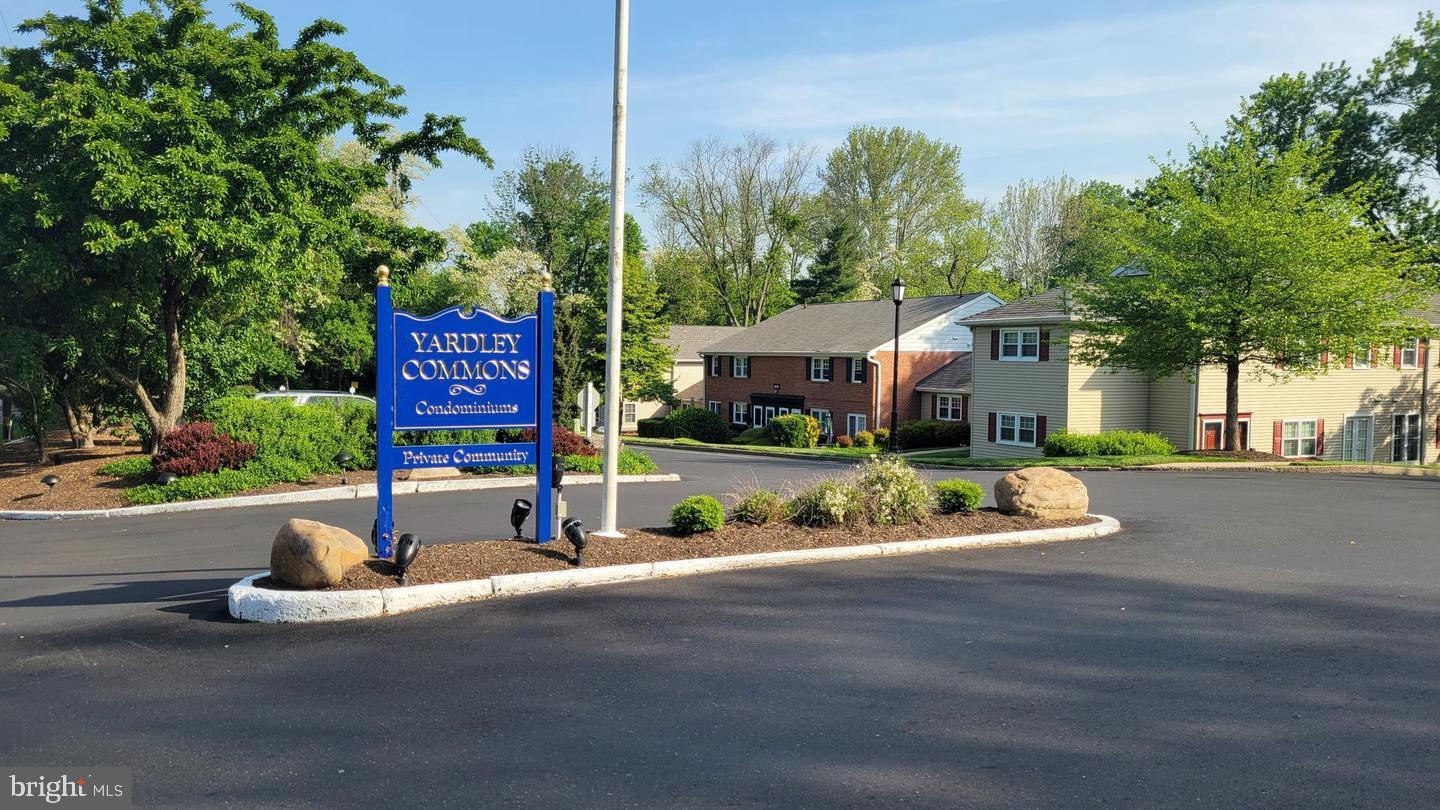 203 Yardley Commons Yardley, PA 19067 - Photo 3 of 12 a front view of a house with a yard and trees