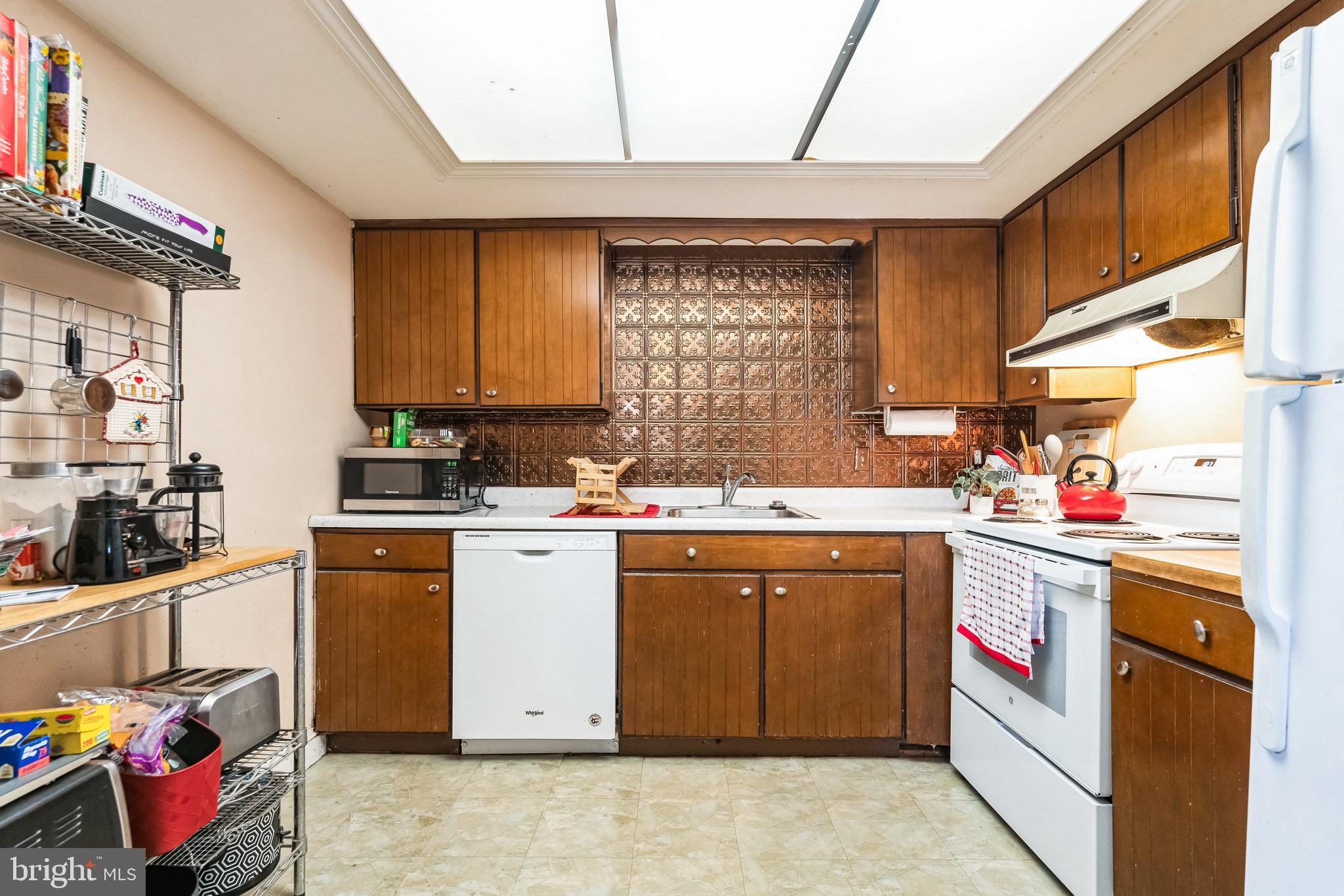 203 Yardley Commons Yardley, PA 19067 - Photo 7 of 12 a kitchen with a sink stove and cabinets
