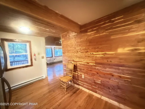 a view of a room with wooden floor