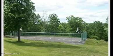 a view of a porch with a table and chairs
