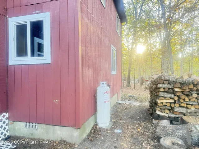 a view of a chairs and table in front of house