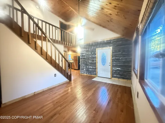 a view of an entryway with wooden floor