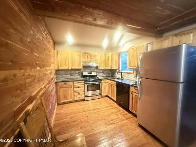 a kitchen with a refrigerator a sink and a stove