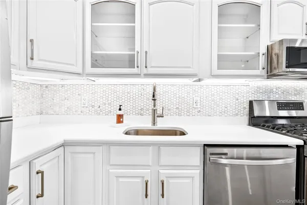 a kitchen with granite countertop a sink and cabinets