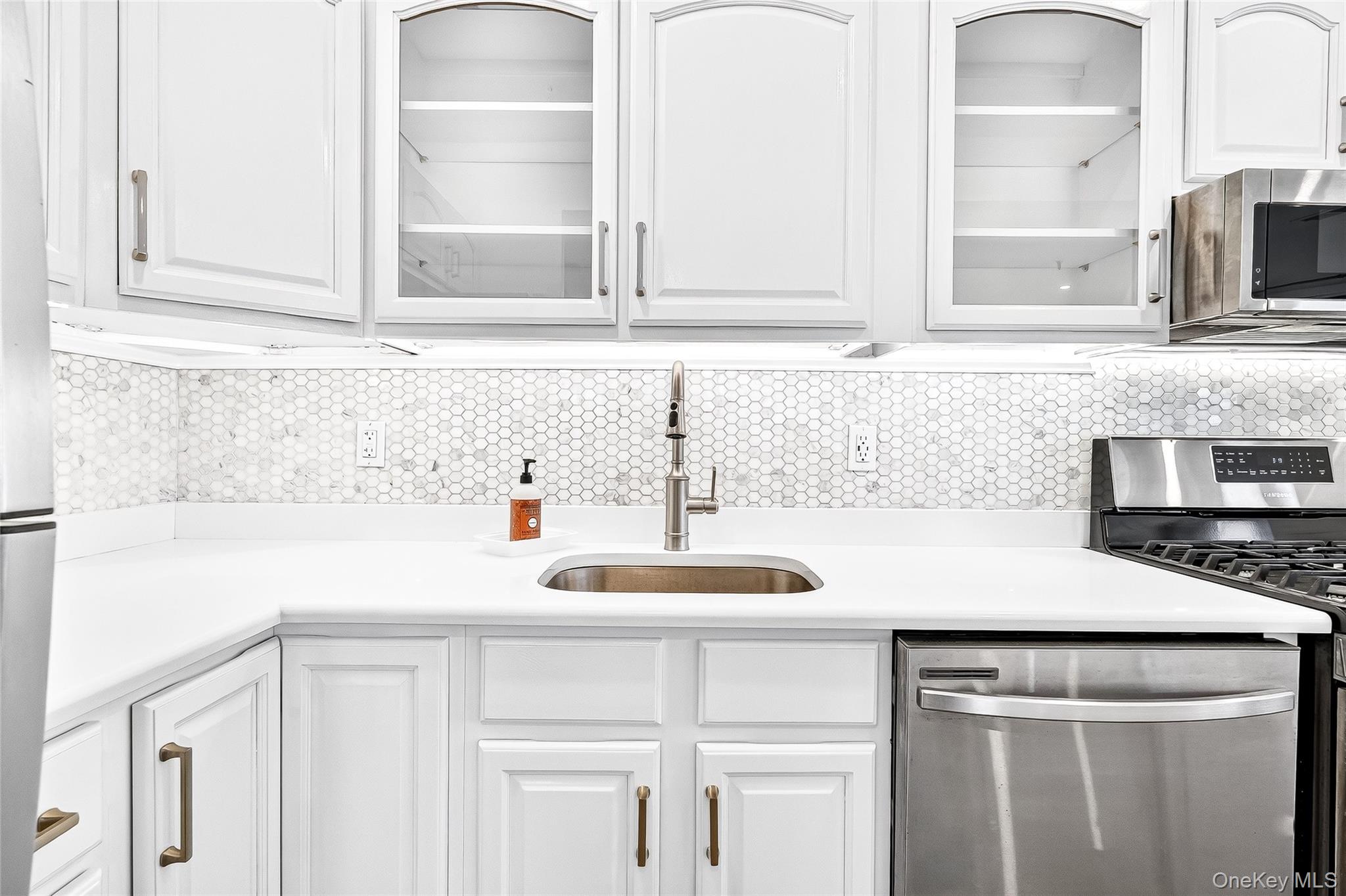 1432 Outlook Avenue, Unit 2 Bronx, NY 10465 - Photo 12 of 39 a kitchen with granite countertop a sink and cabinets
