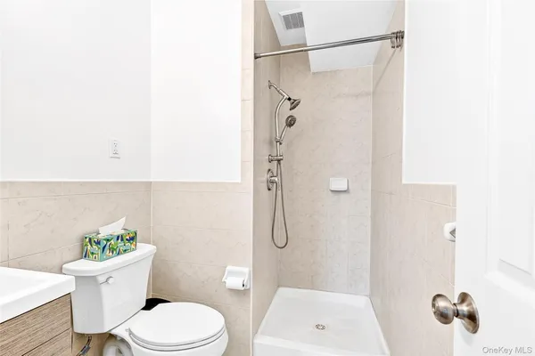 a white toilet sitting next to a bathroom sink