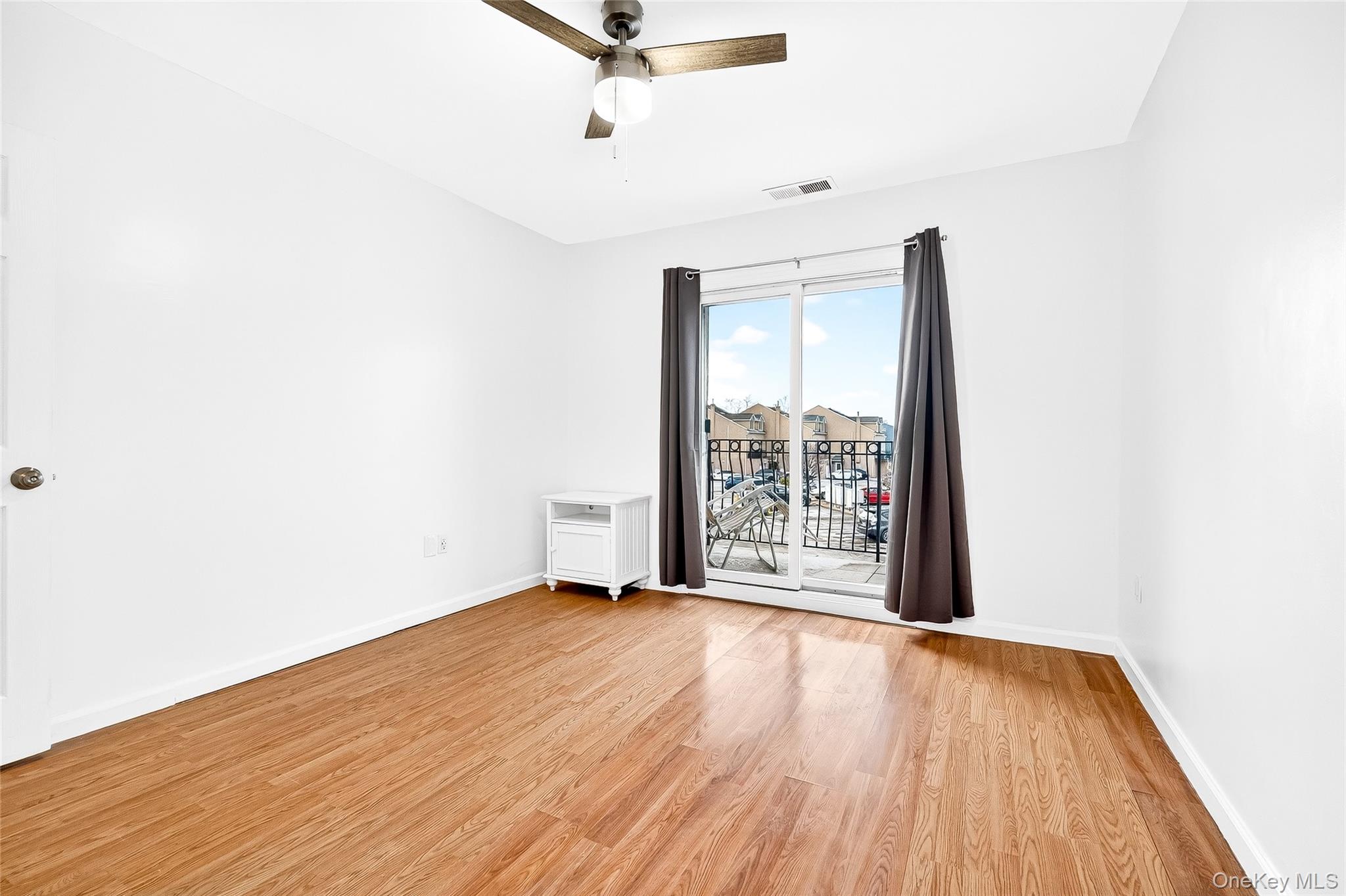1432 Outlook Avenue, Unit 2 Bronx, NY 10465 - Photo 27 of 39 a view of an empty room with wooden floor and a window