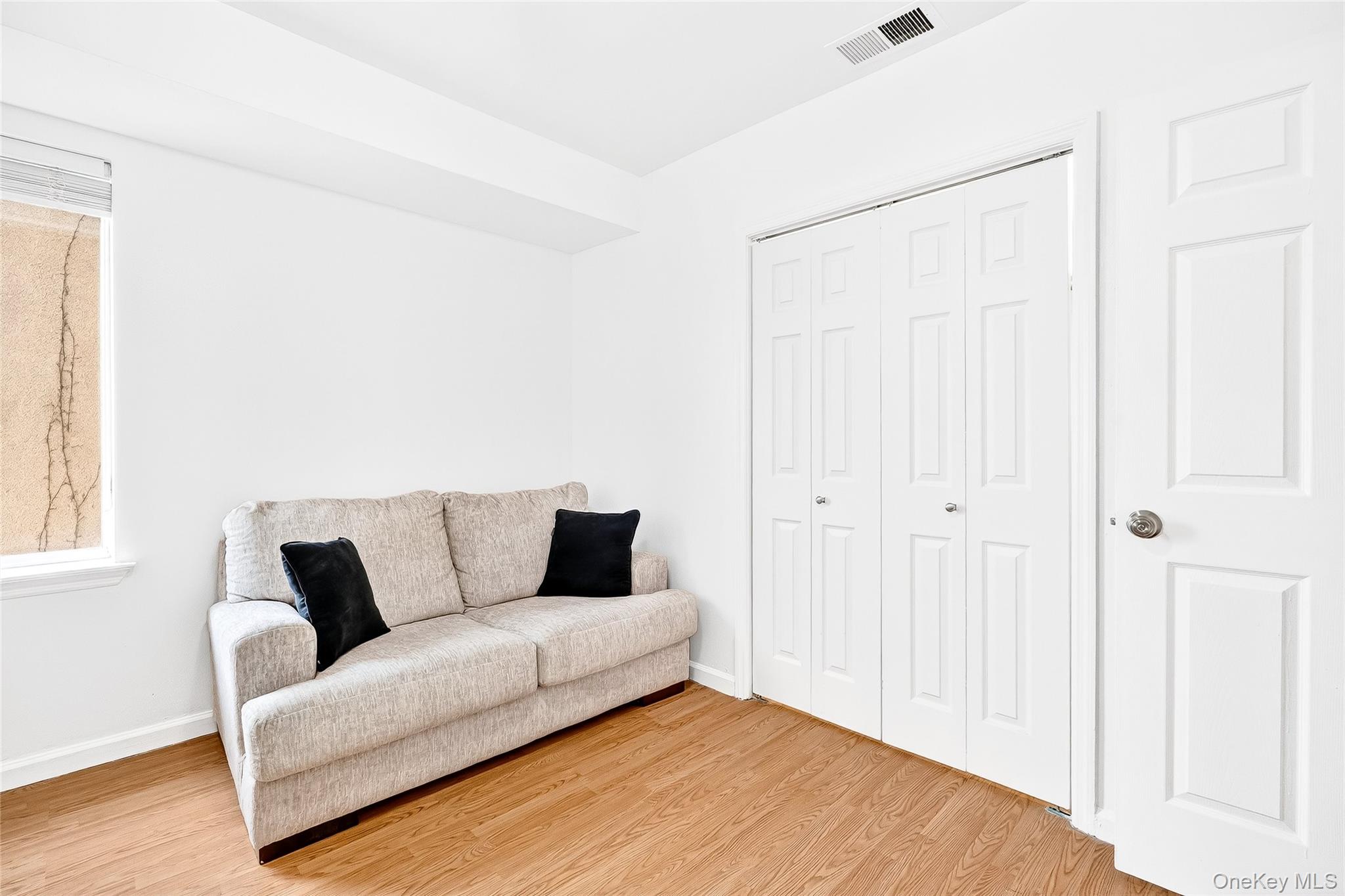 1432 Outlook Avenue, Unit 2 Bronx, NY 10465 - Photo 32 of 39 a living room with furniture and a couch