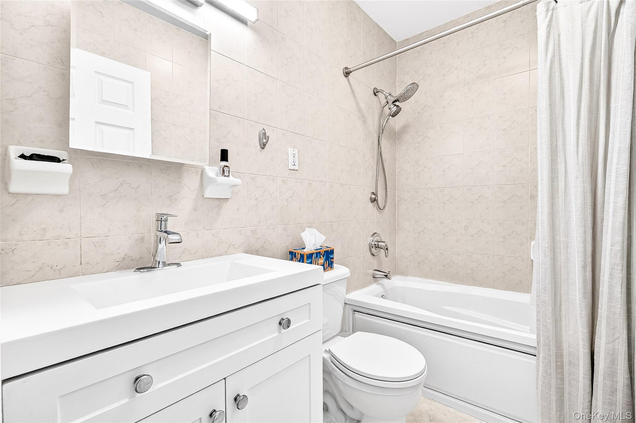 1432 Outlook Avenue, Unit 2 Bronx, NY 10465 - Photo 34 of 39 a bathroom with a sink a mirror toilet and bathtub