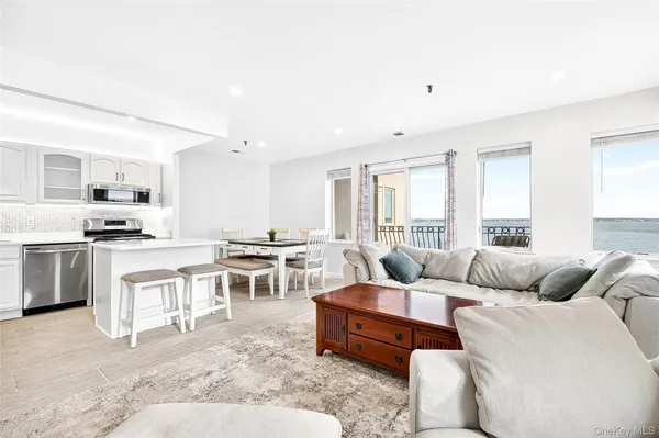 a living room with furniture and view kitchen