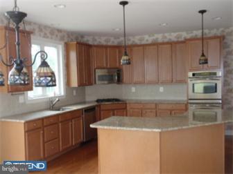 51 Curtmantle Road Mickleton, NJ 08056 - Photo 3 of 12 a kitchen with stainless steel appliances granite countertop a sink a stove and a wooden floors