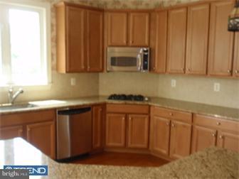 51 Curtmantle Road Mickleton, NJ 08056 - Photo 4 of 12 a kitchen with stainless steel appliances granite countertop a sink a stove and a microwave