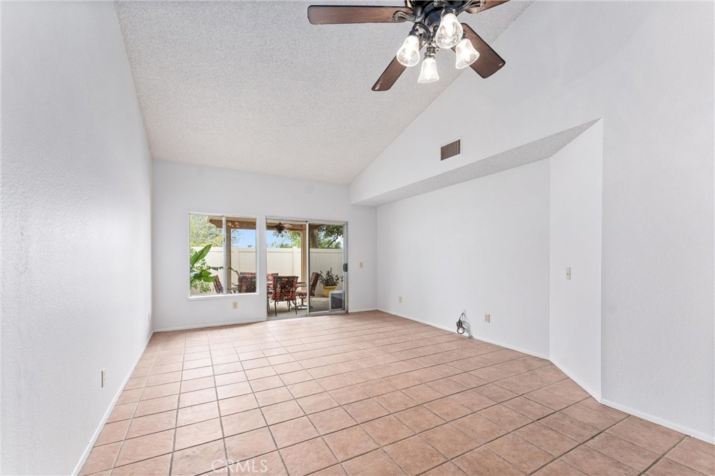 1159 Stone Pine Lane, Unit C Corona, CA 92879 - Photo 11 of 25 a view of empty room with window and chandelier fan
