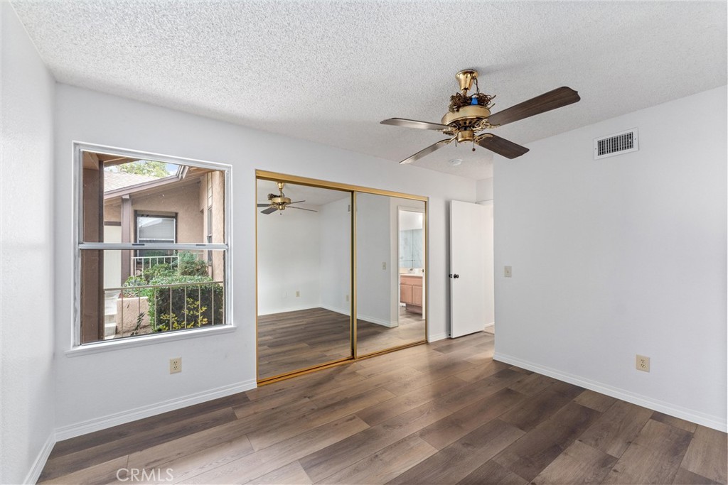 1159 Stone Pine Lane, Unit C Corona, CA 92879 - Photo 15 of 25 a view of an empty room with a window and wooden floor