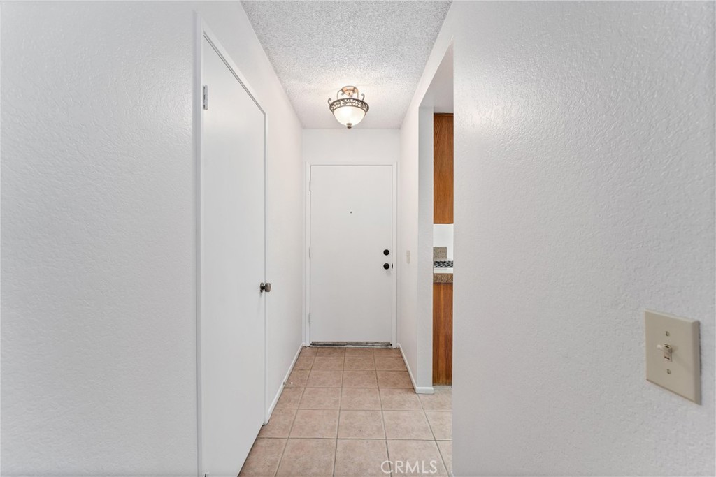 1159 Stone Pine Lane, Unit C Corona, CA 92879 - Photo 16 of 25 a view of a hallway with wooden floor and closet