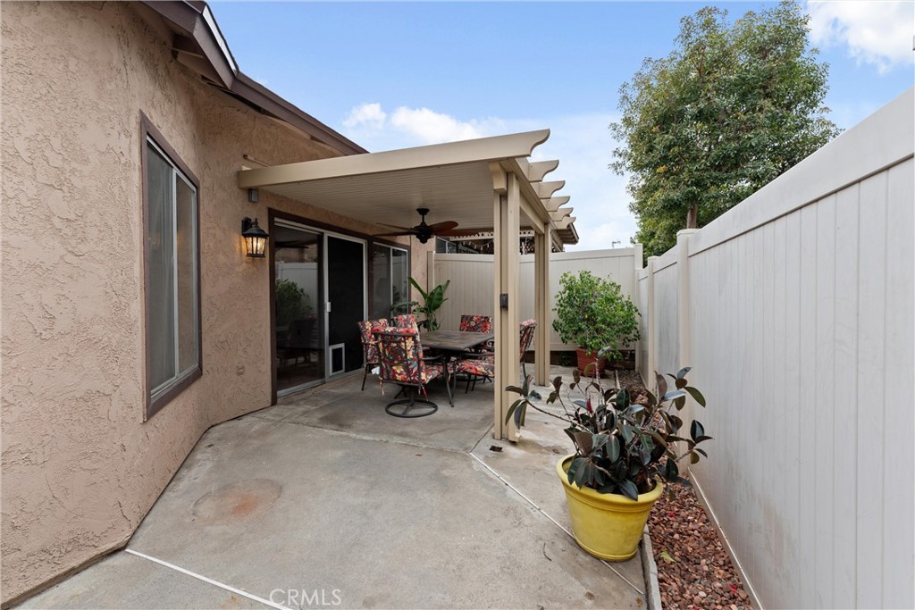 1159 Stone Pine Lane, Unit C Corona, CA 92879 - Photo 20 of 25 a view of a patio with table and chairs and potted plants